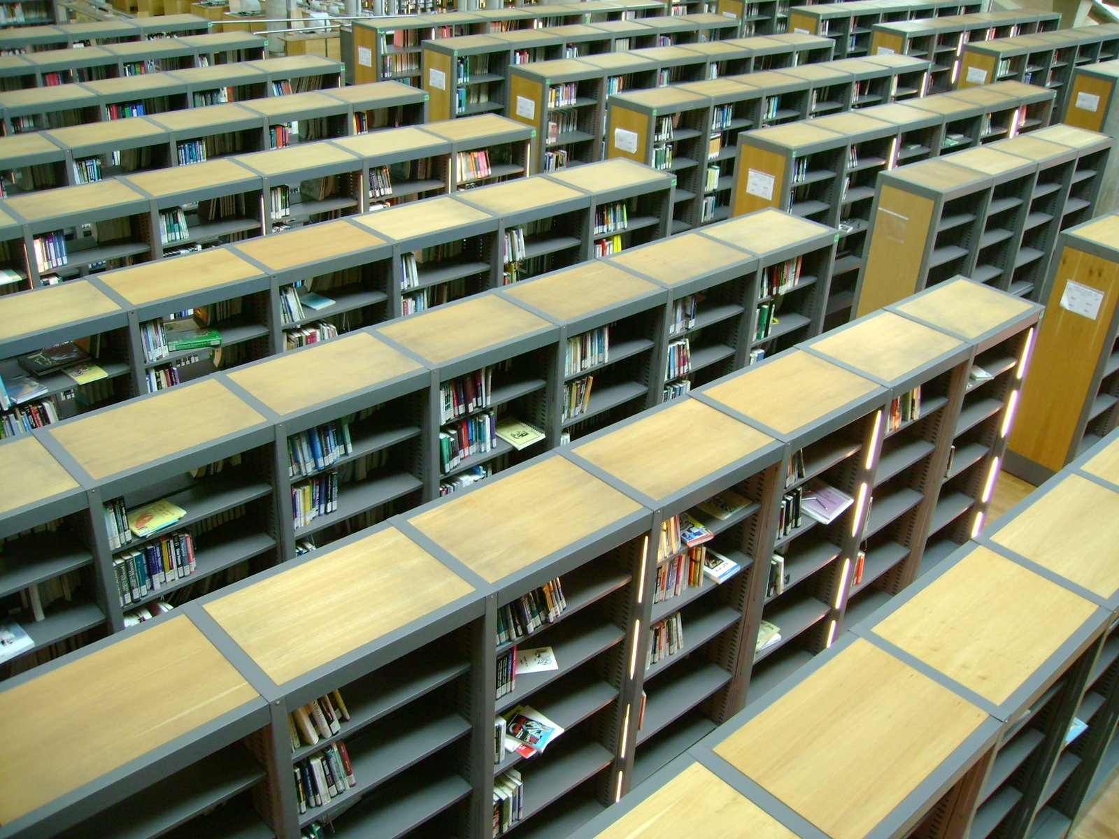 an auditorium filled with wooden shelving shelves with books