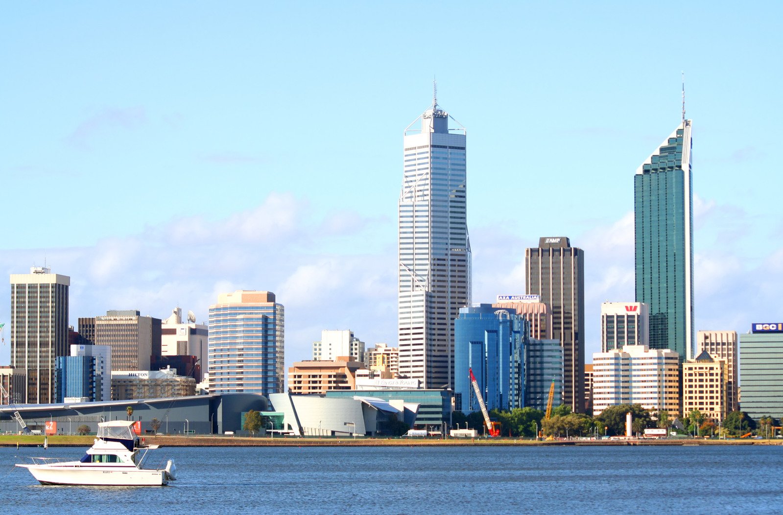 the boats are in the water and there is a city