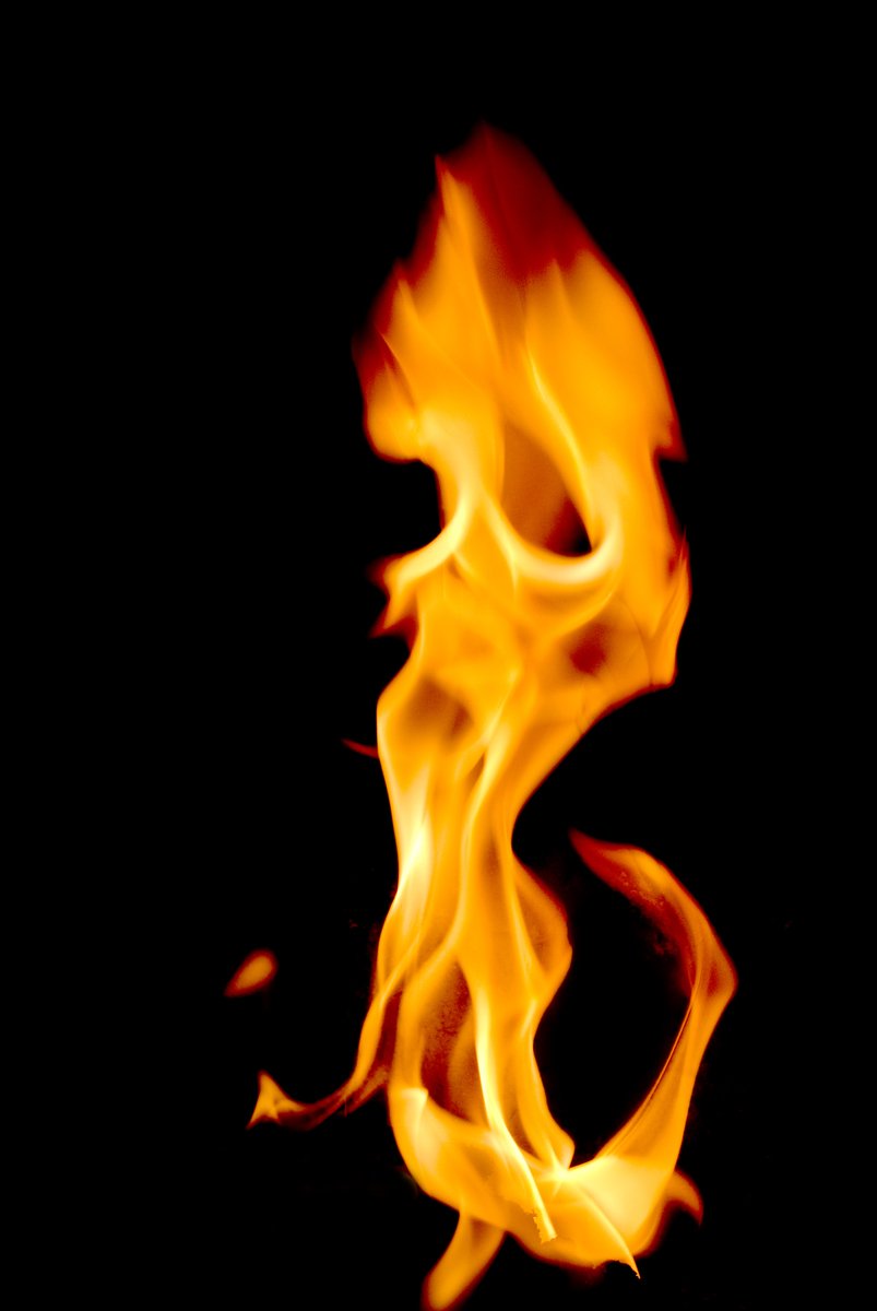 a close - up po of a fire on a black background