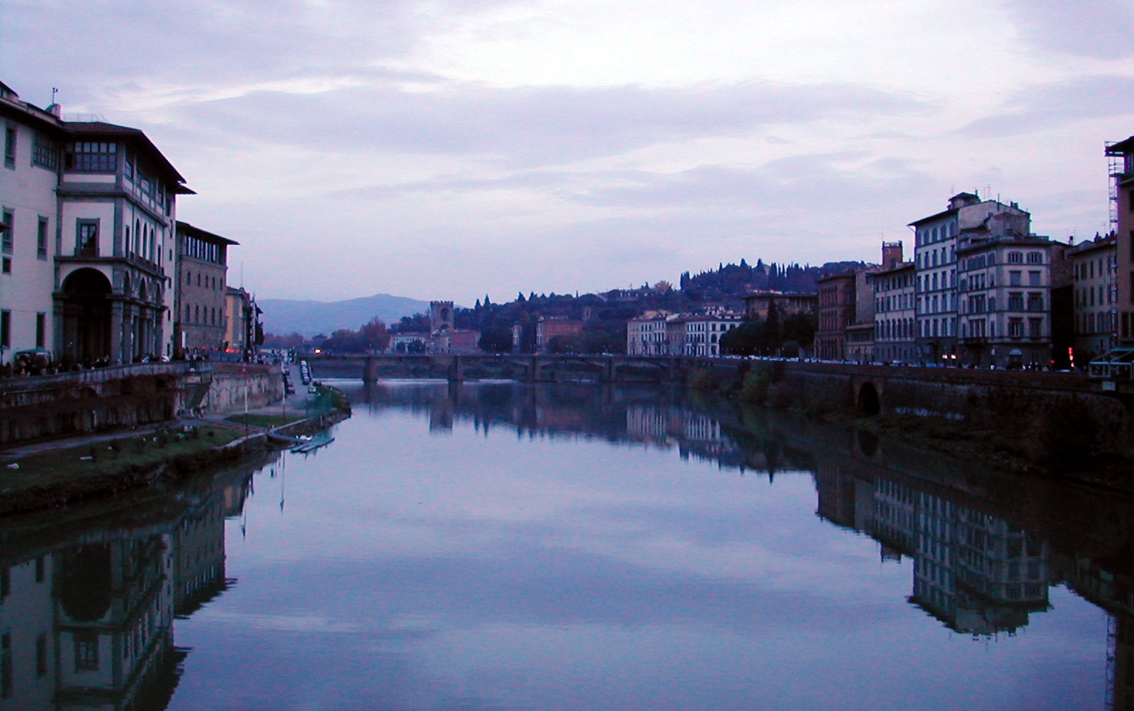 a river with buildings on the banks and buildings in the background