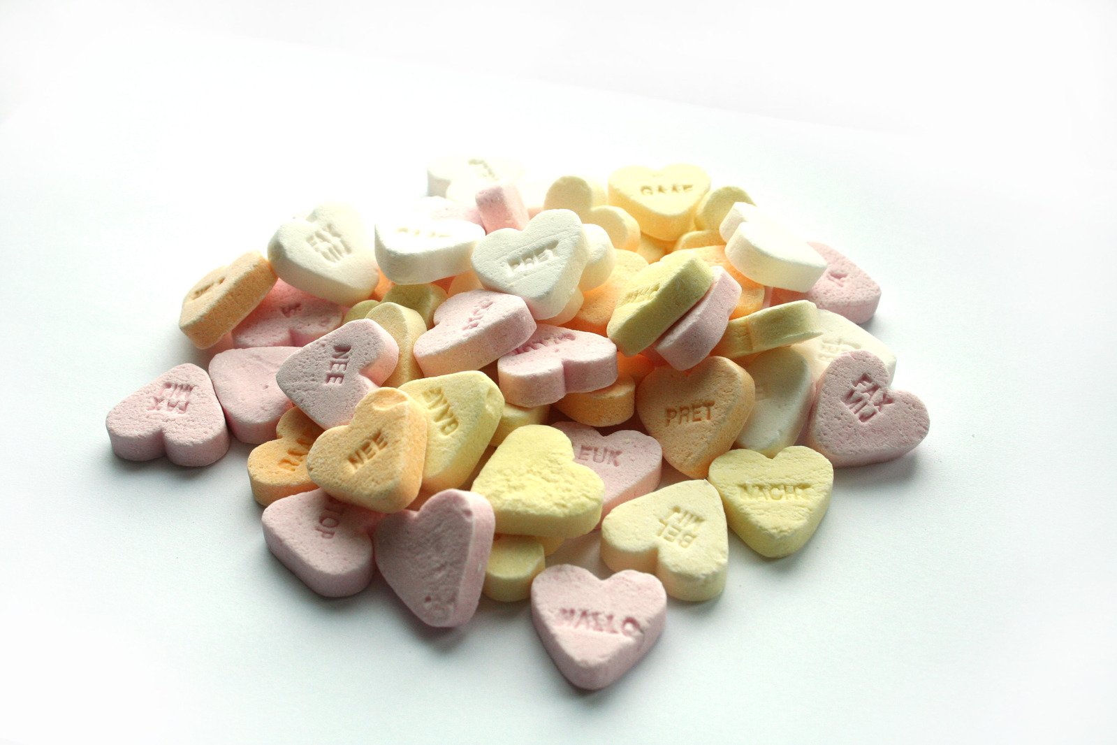 several hearts shaped conversation hearts sitting next to each other