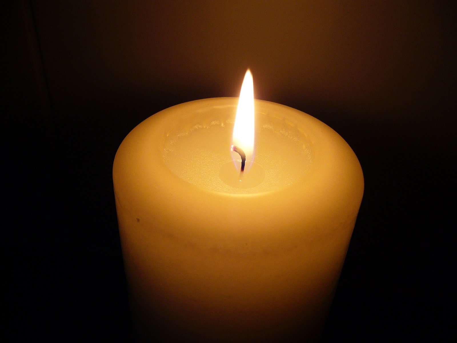 a candle sitting in a dark place