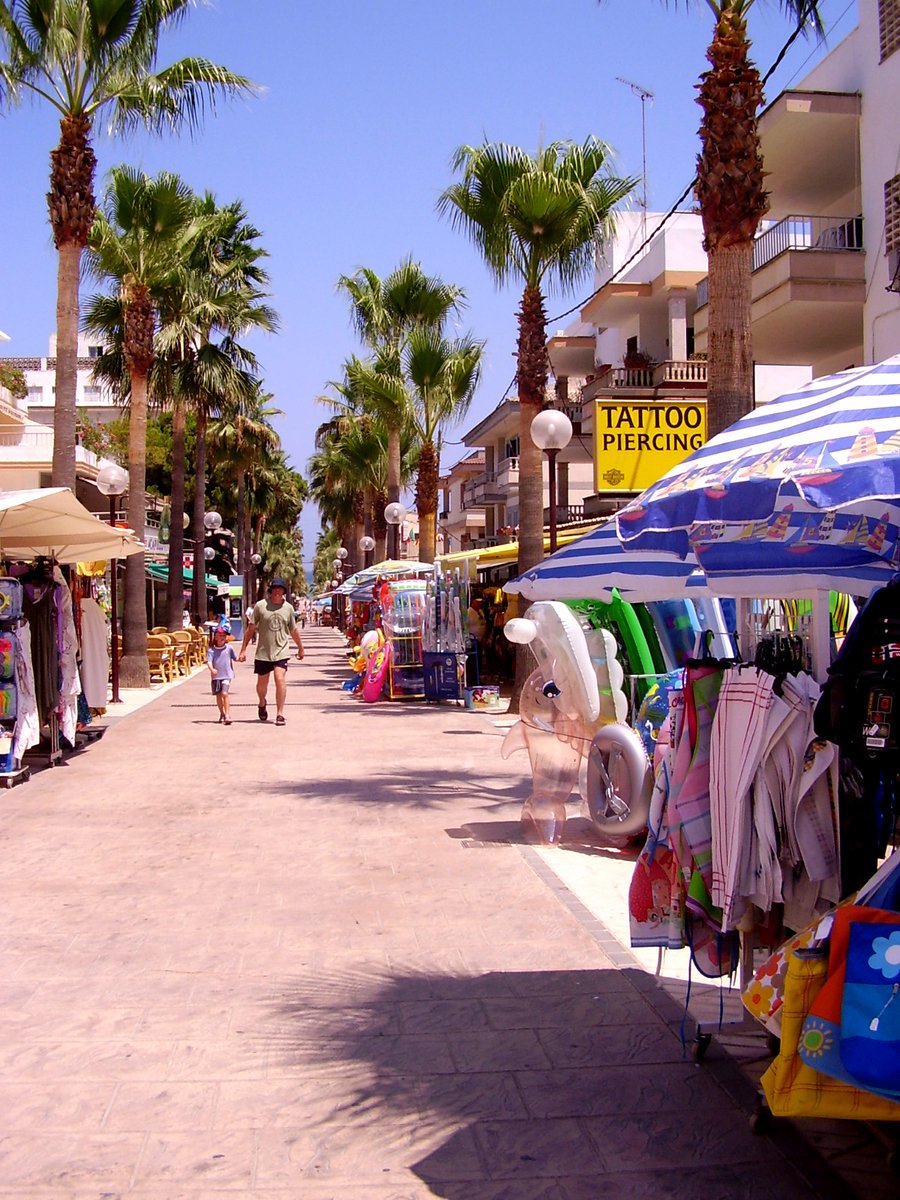 many shops near the beach have umbrellas in them