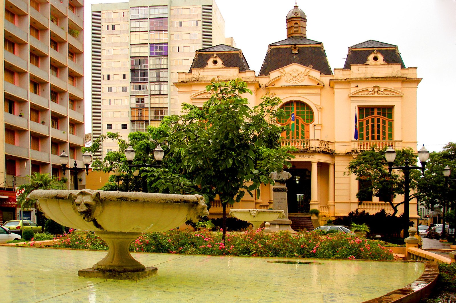 a building that has plants around a fountain