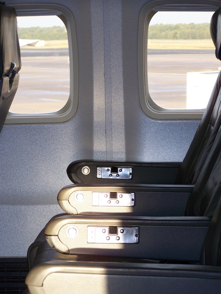several seats are on a seat divider and some windows are open