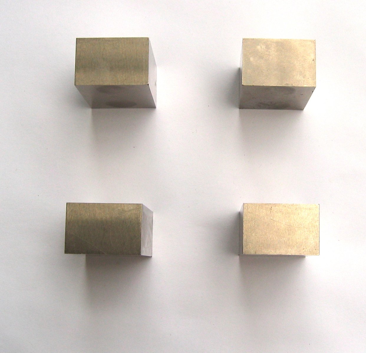 three square and rectangular magnets are placed on a table