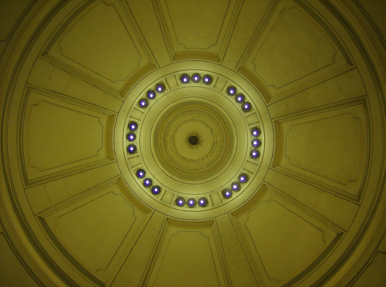 the inside of a very circular building with lights