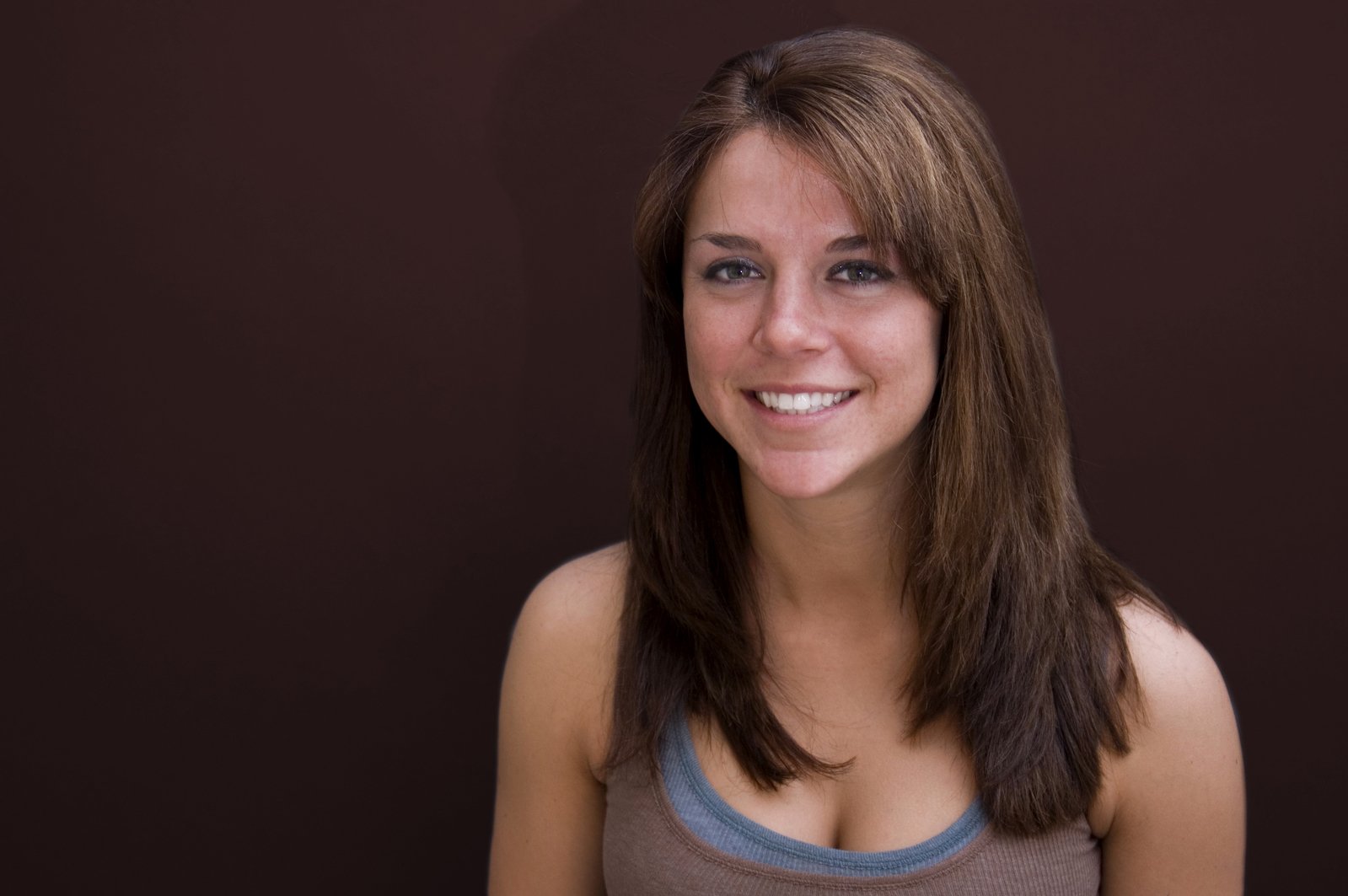a woman in tank top smiling for a portrait
