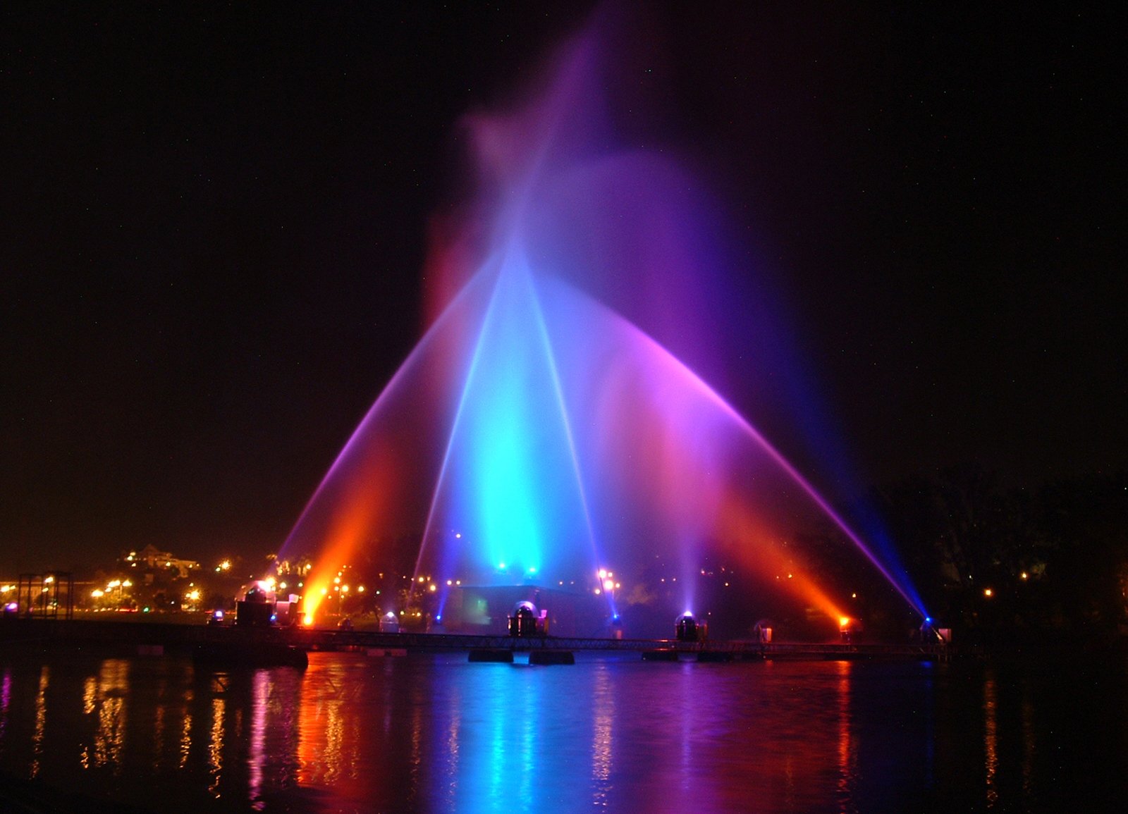 colorful fountains in the middle of a city at night