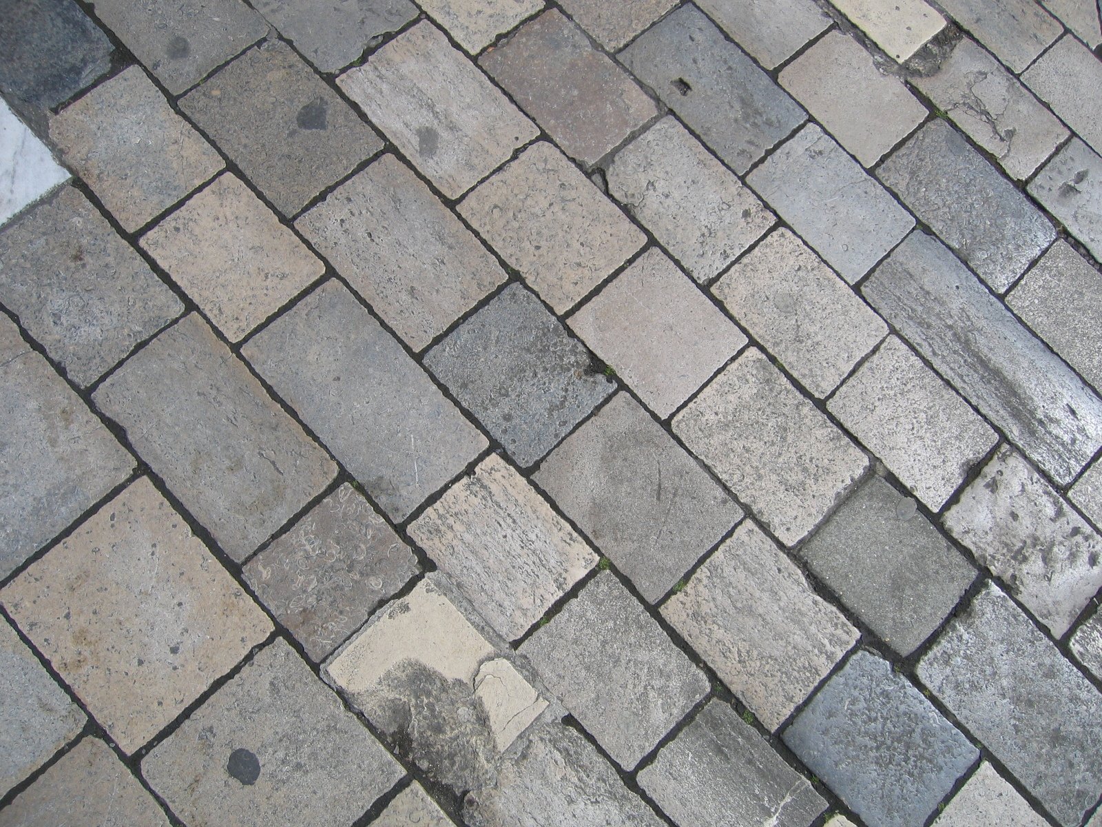 a view of an outdoor brick sidewalk, taken from above