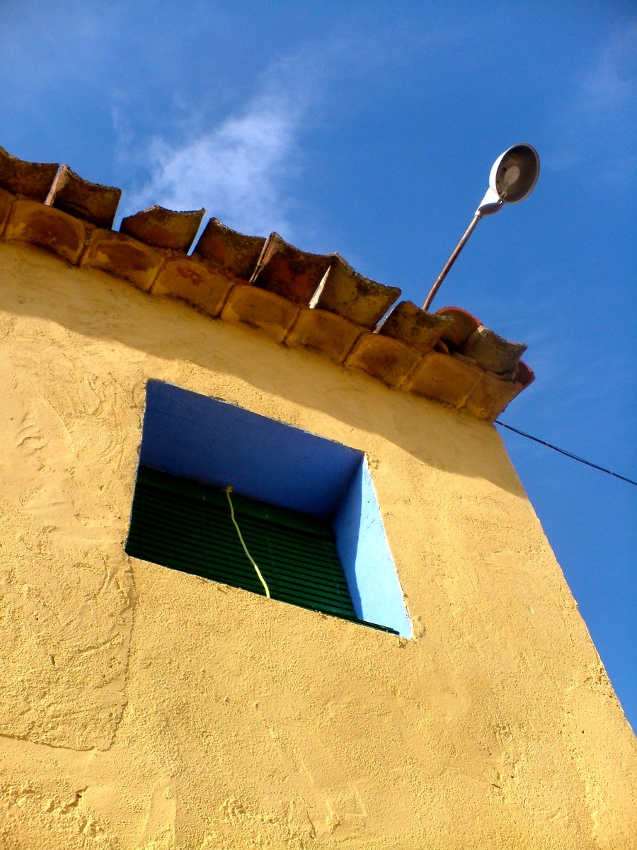 a building with a window and a street light