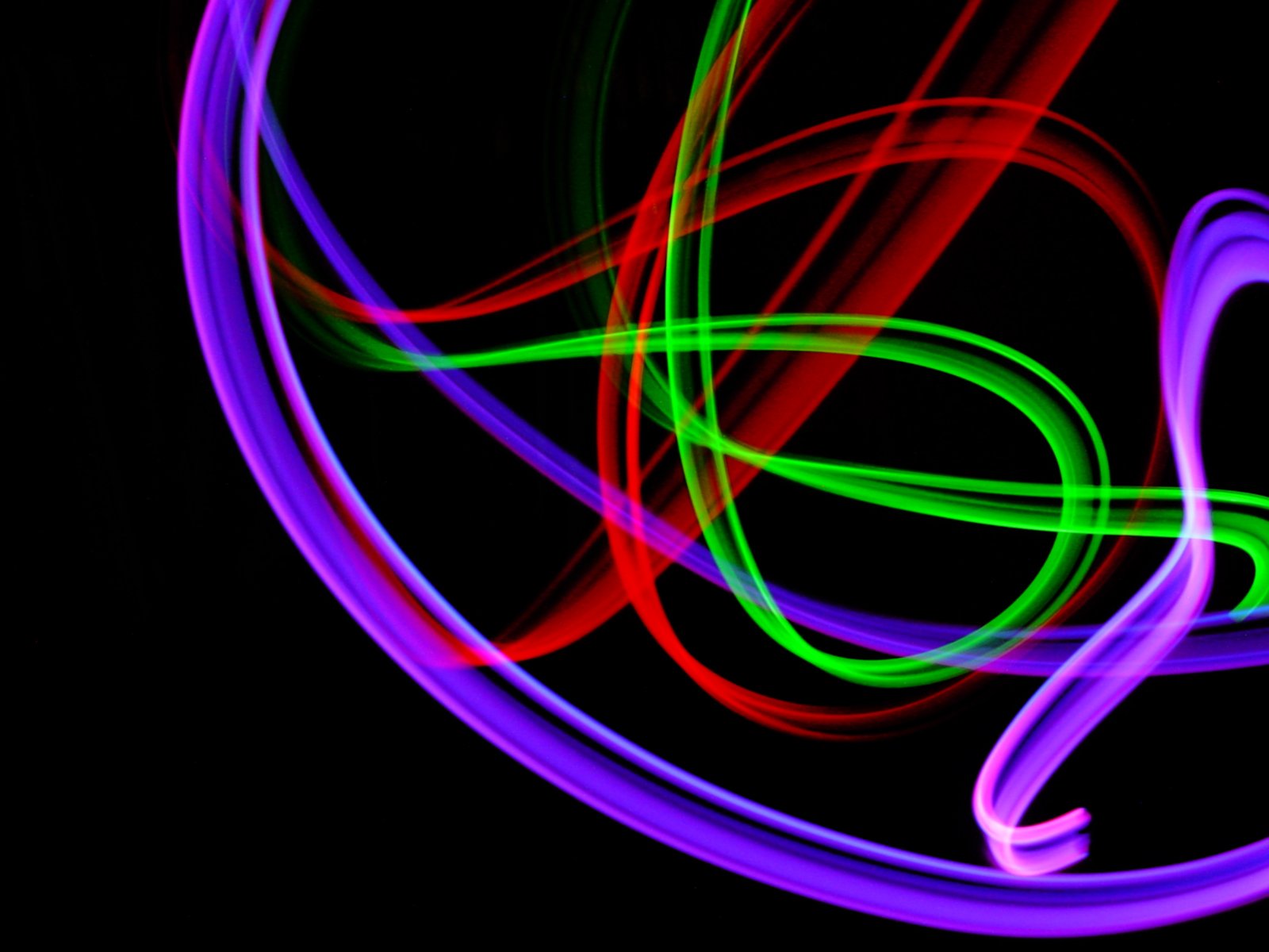 a colorful neon po of swirling ribbons against black