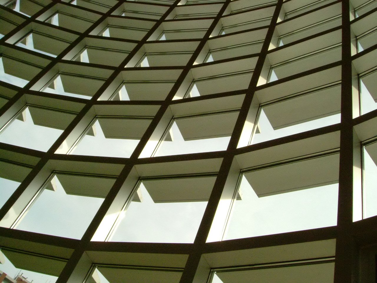 a close up of the corner of a building with many windows