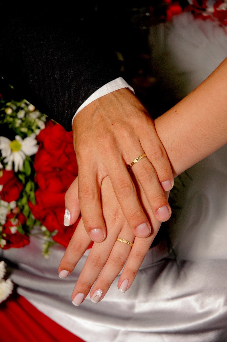 wedding couple holding hands while on their wedding day