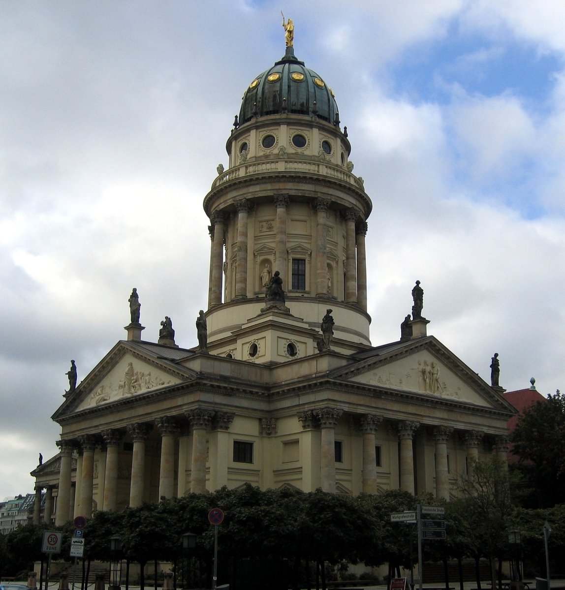 an old building with a domed tower under clouds
