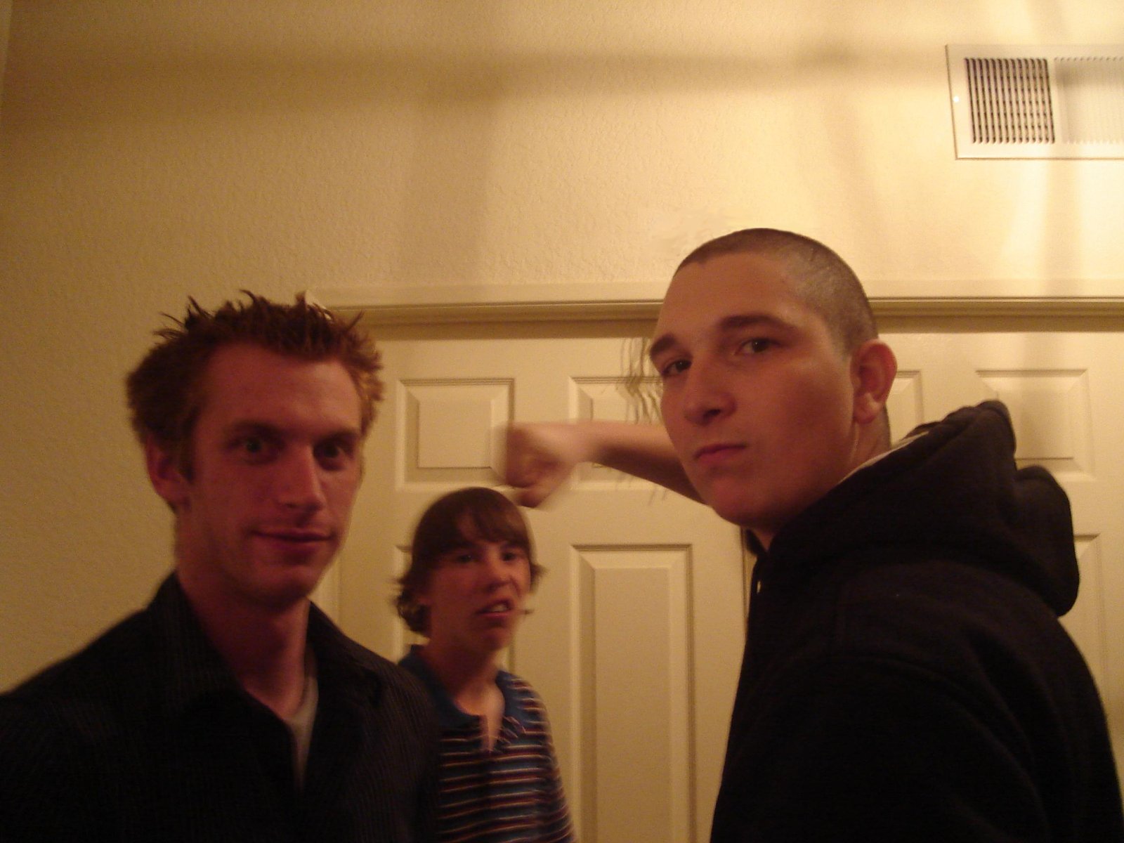 two men are posing for a pograph in a living room