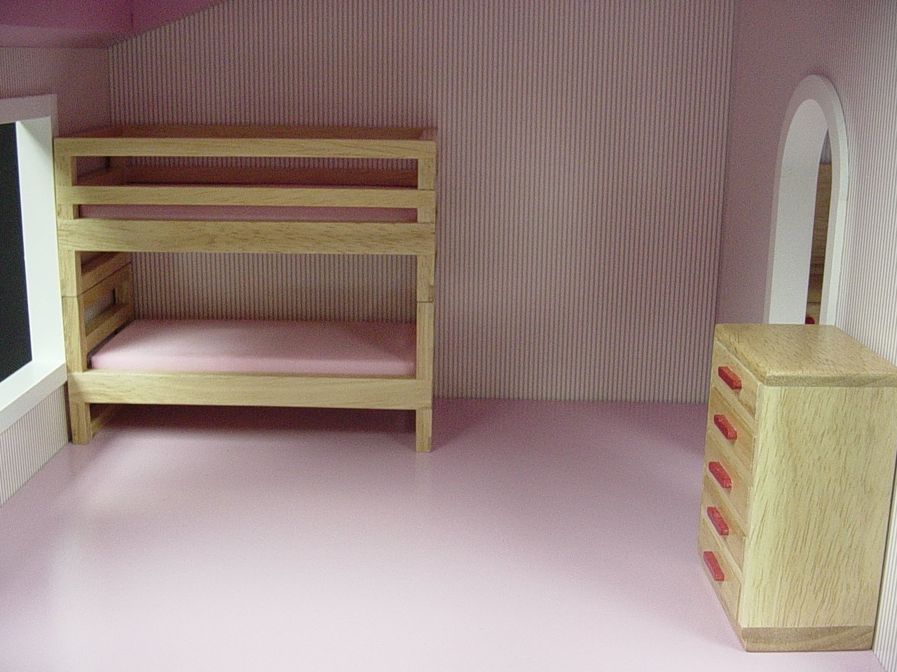 a room with a bunk bed and two drawers