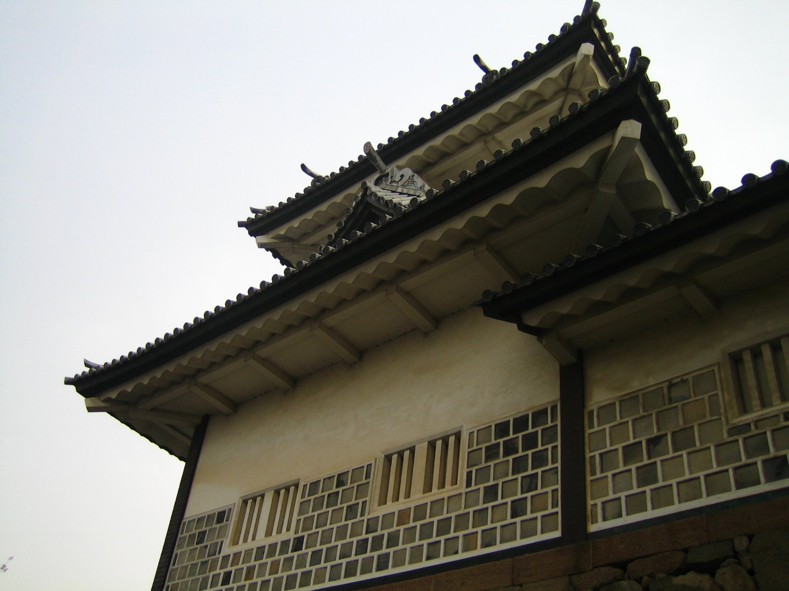 a building with a weather vane and window panes