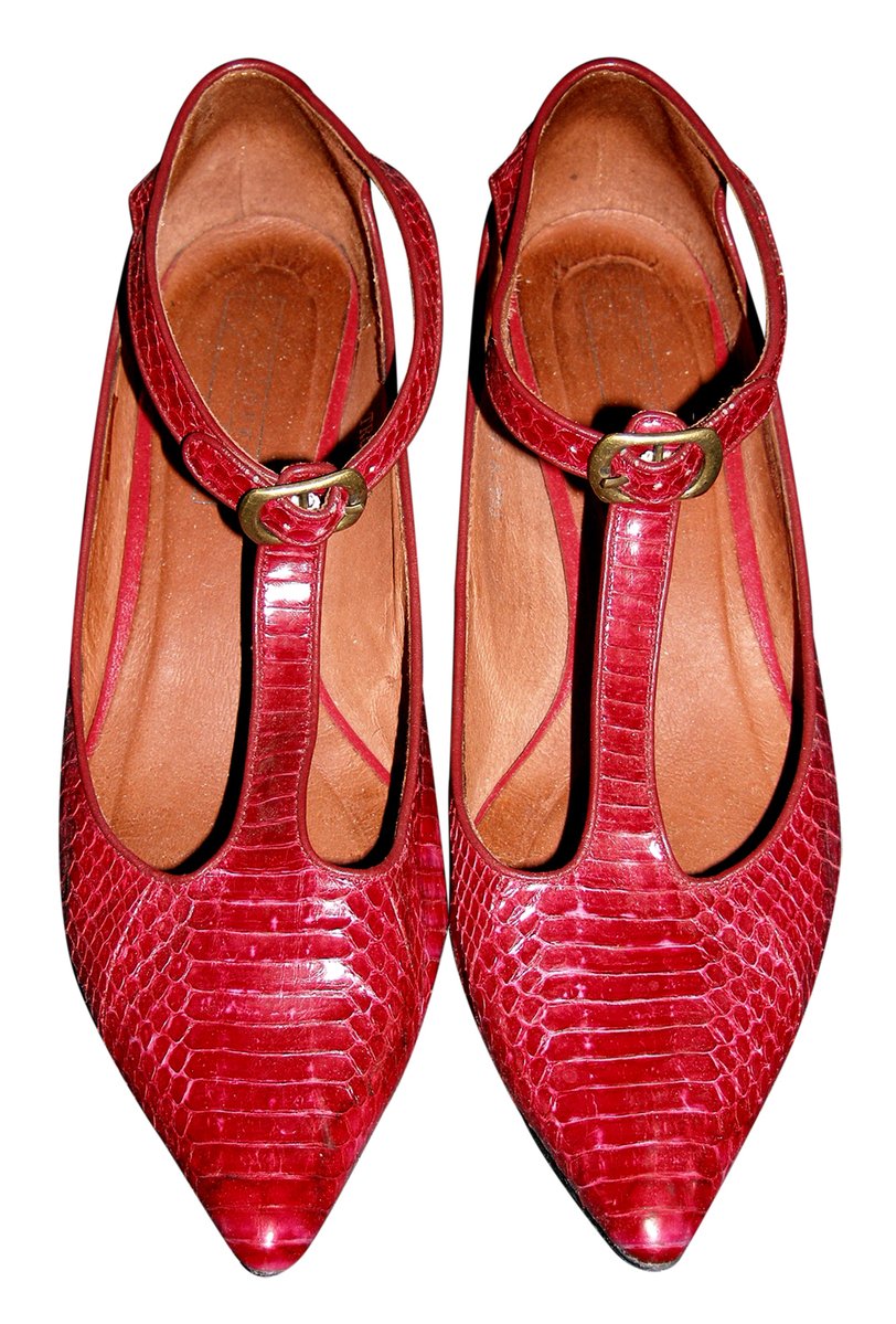 a pair of red shoes is shown with the heel high