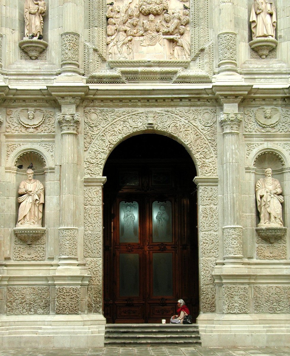 there is a person sitting outside a building