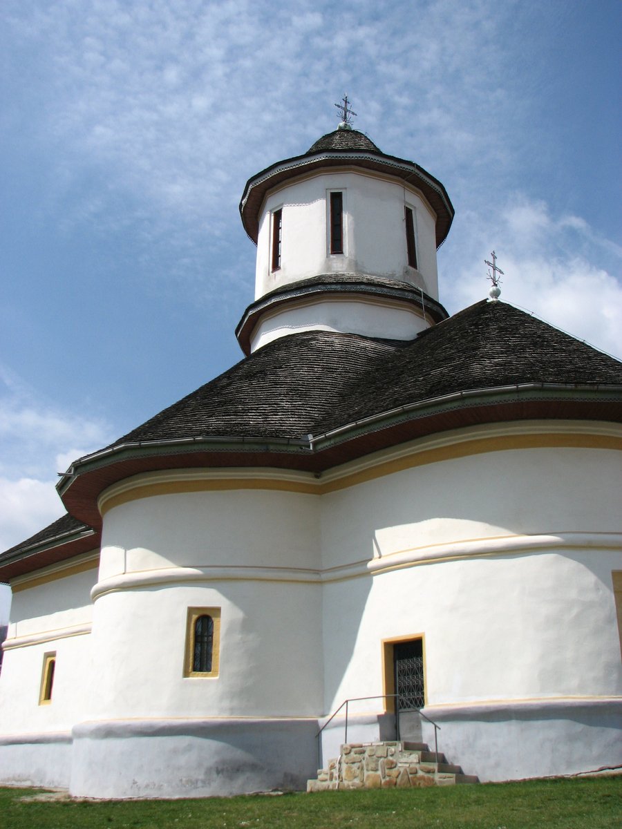 a white church with a cross at the top