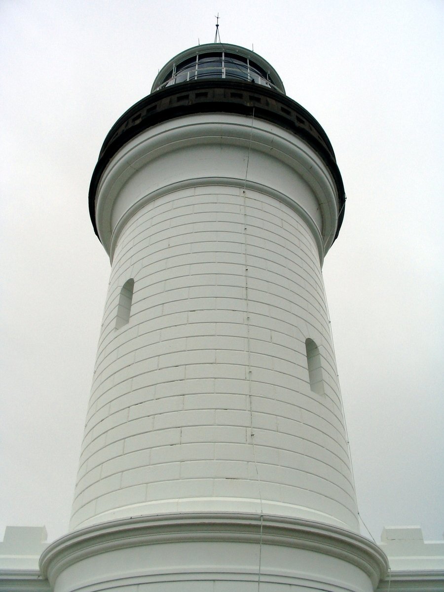 a light house in the middle of an overcast sky