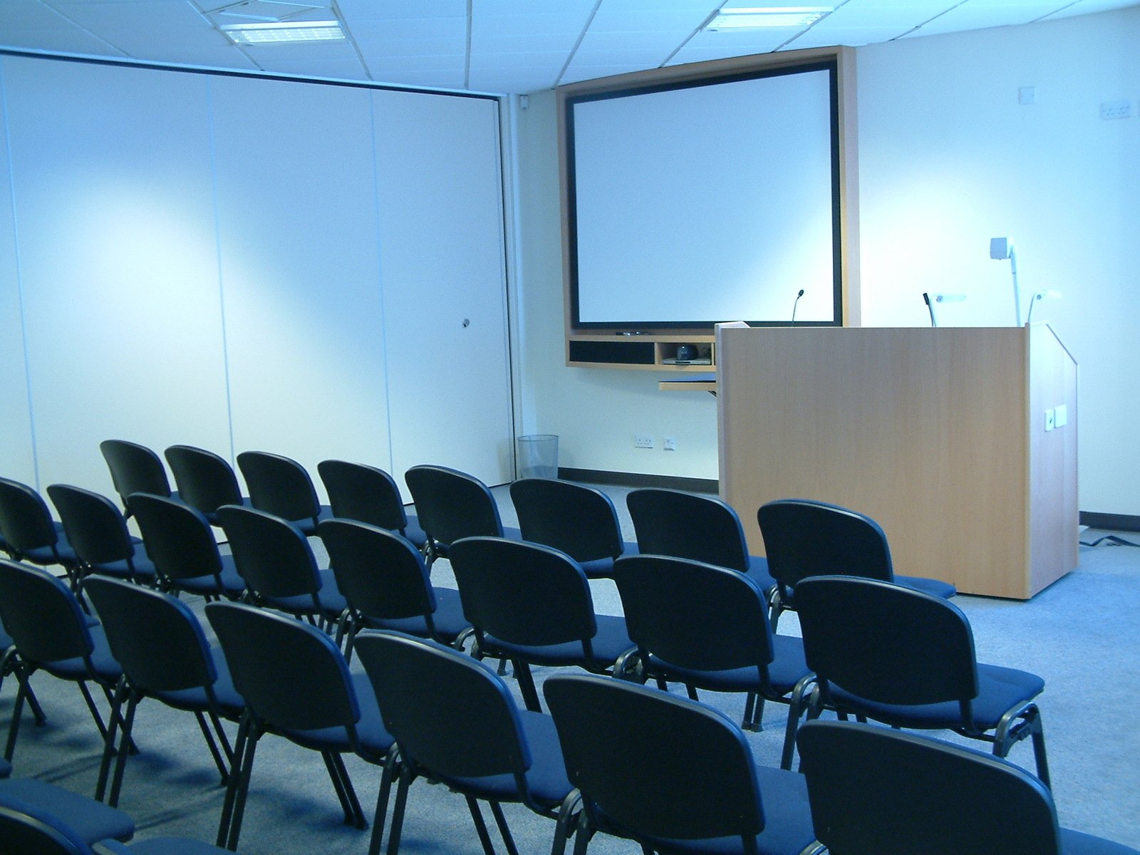 a conference room full of chairs with a podium