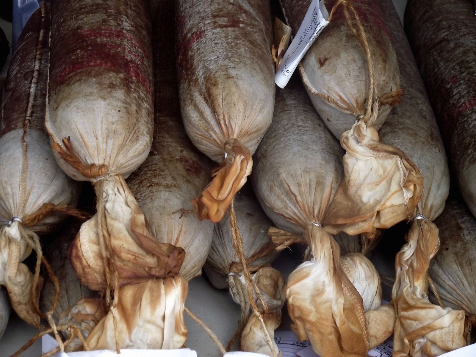 a large pile of garlic hanging from hooks