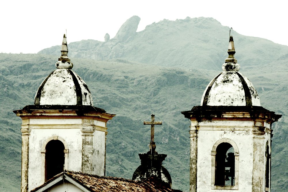 a church steeple is next to another church tower