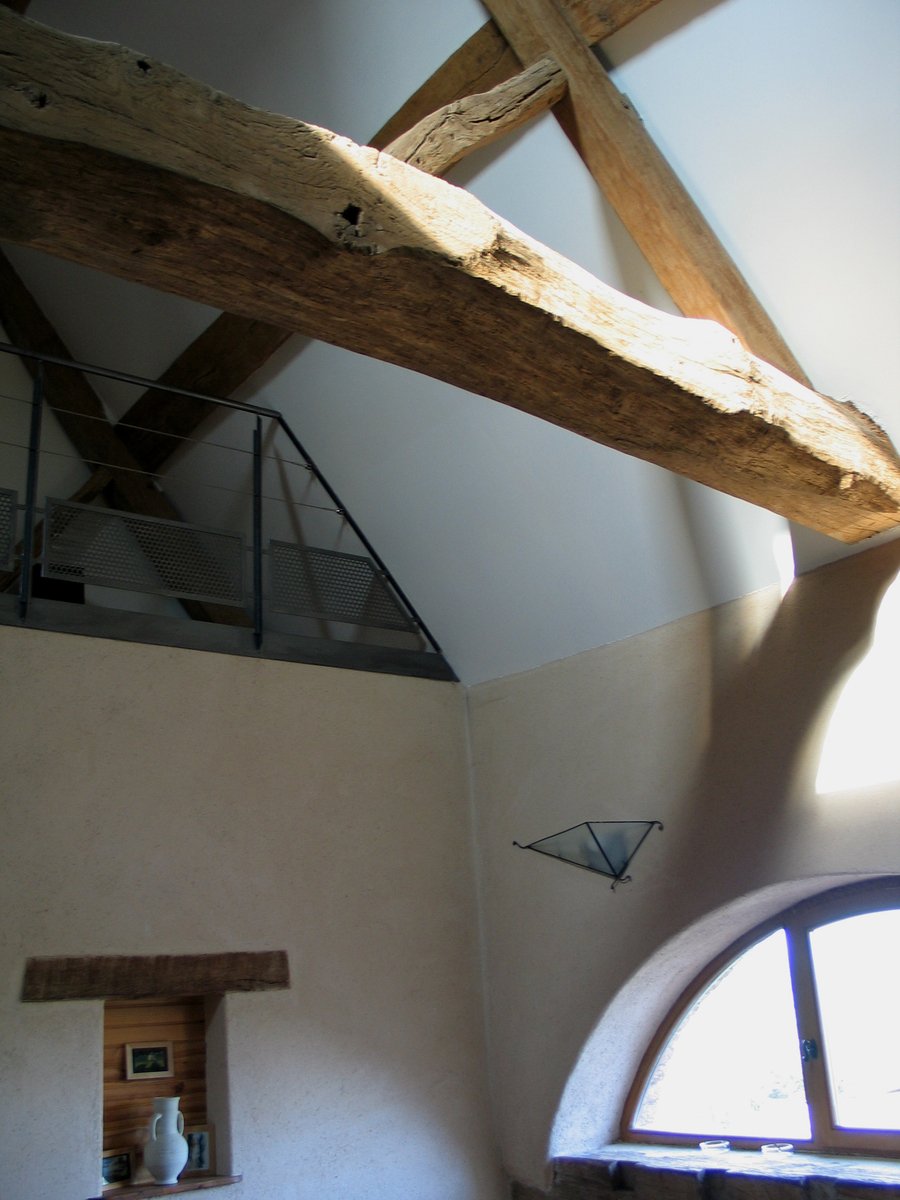a small room with wood beam and exposed ceiling