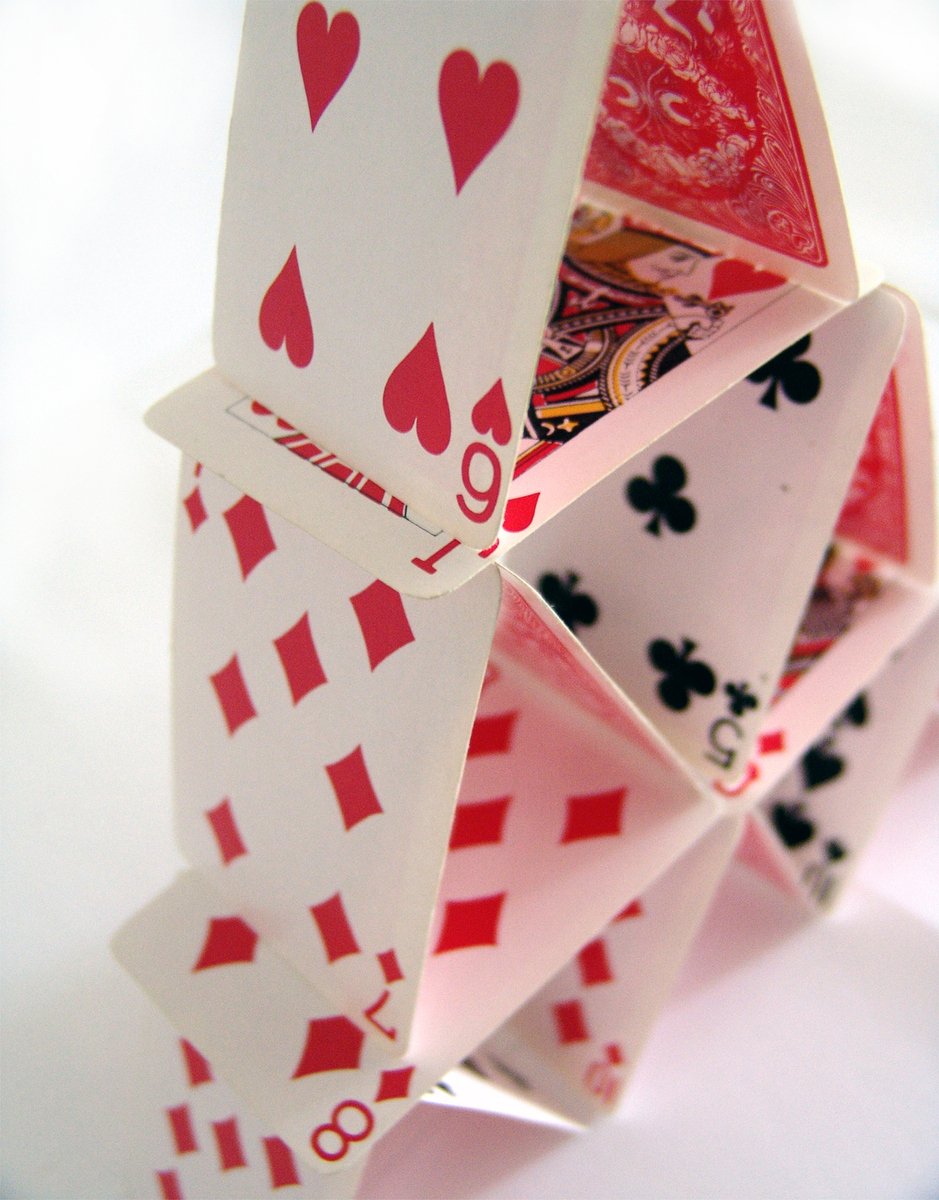 four stacks of cards folded together in order to form a pyramid