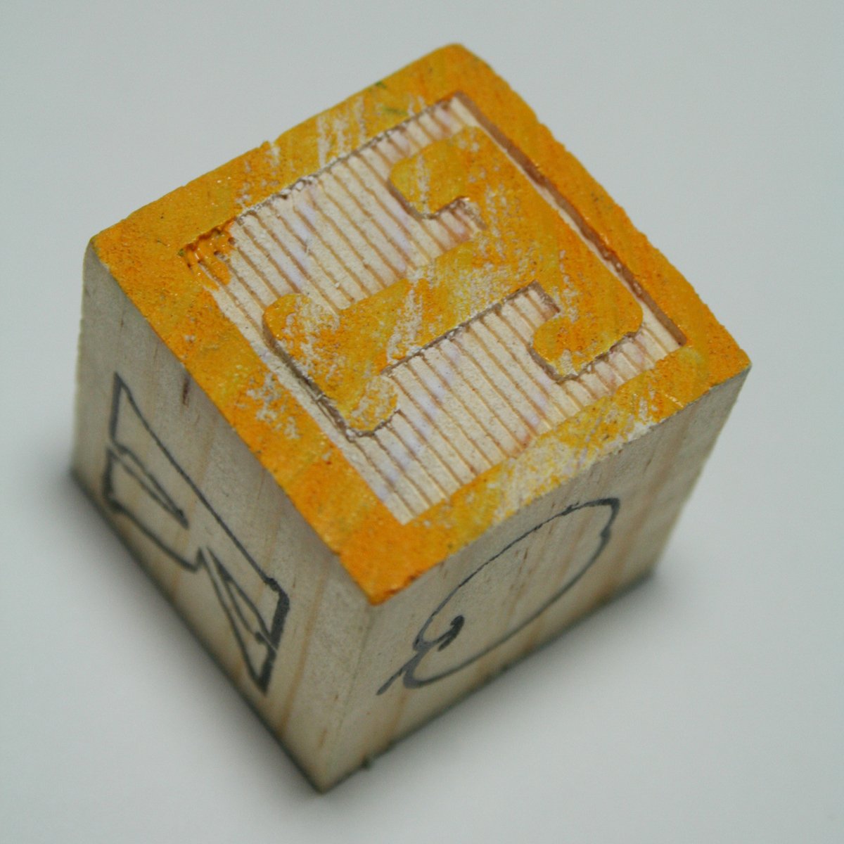this is a small box with the letter e carved in