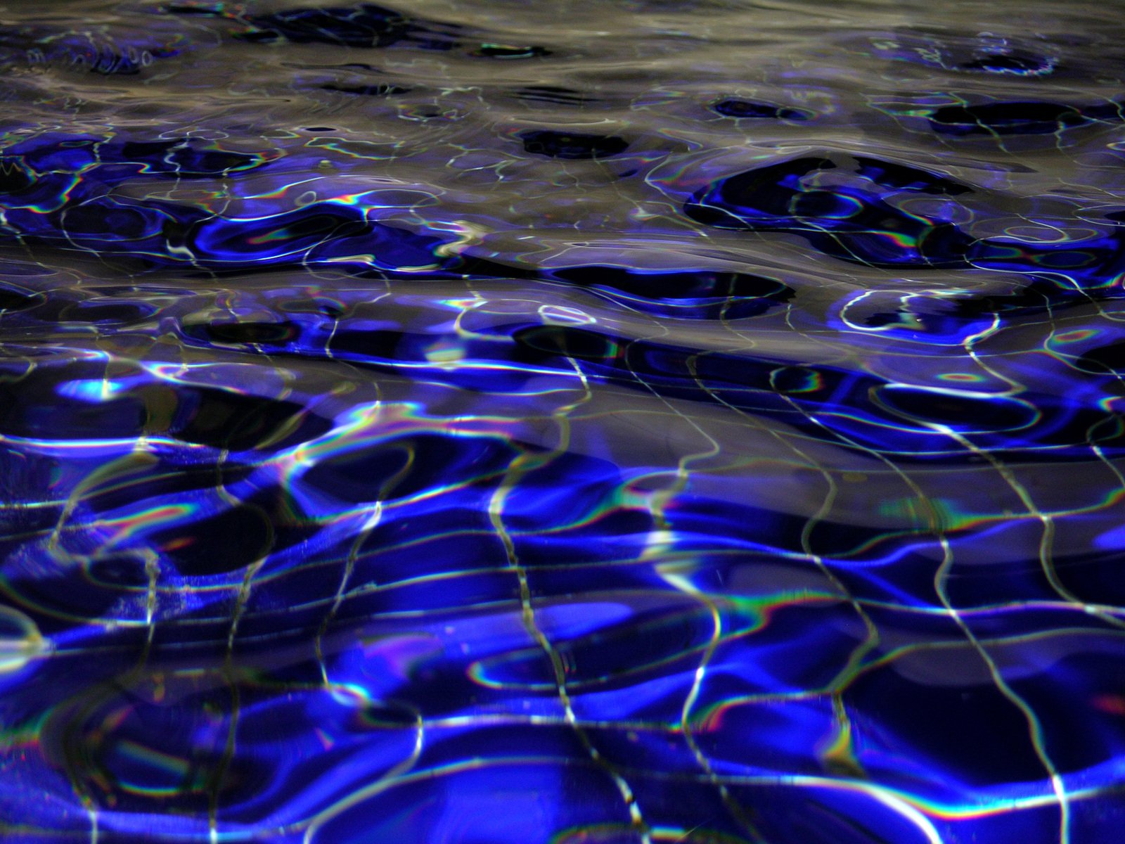 blue water in a pool surrounded by bubbles