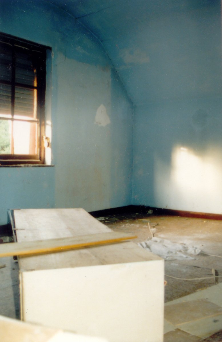 a room with blue walls and wooden floors