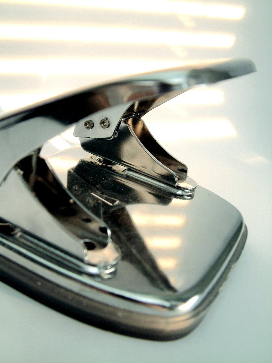 the hood ornament on a car parked at a dealership