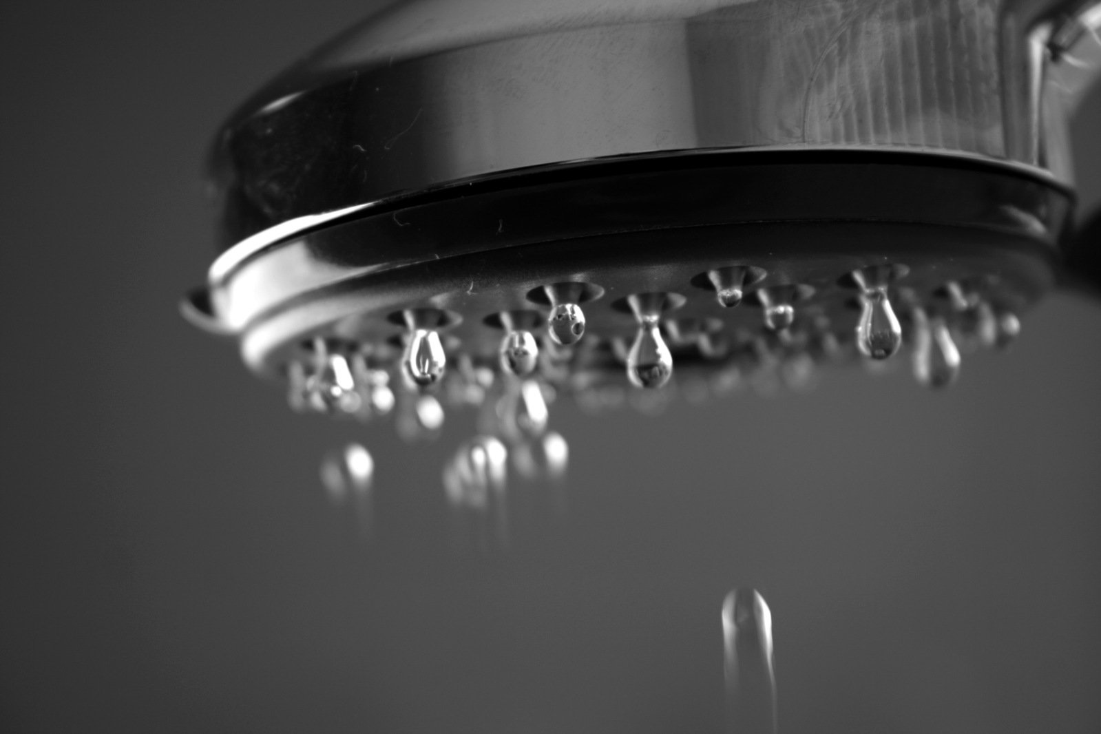 a rain shower head with some water running down