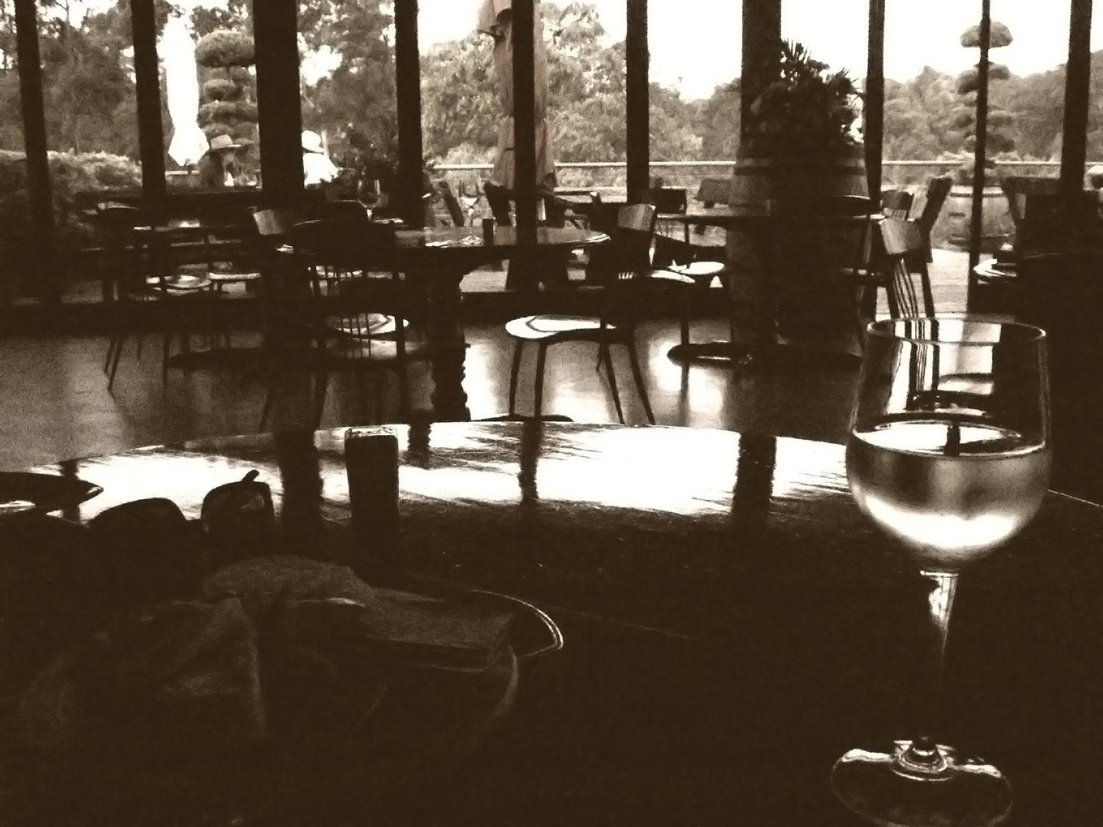 an empty wine glass sits on the floor in a restaurant