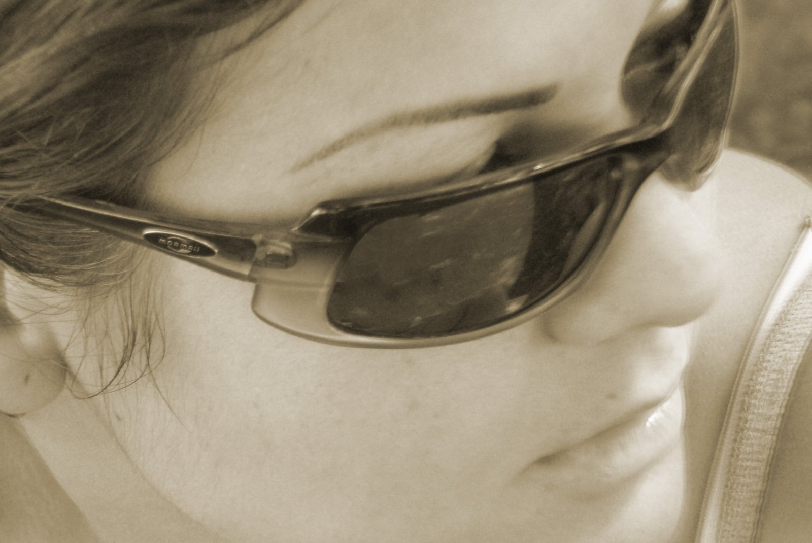 a person in sunglasses using their cell phone
