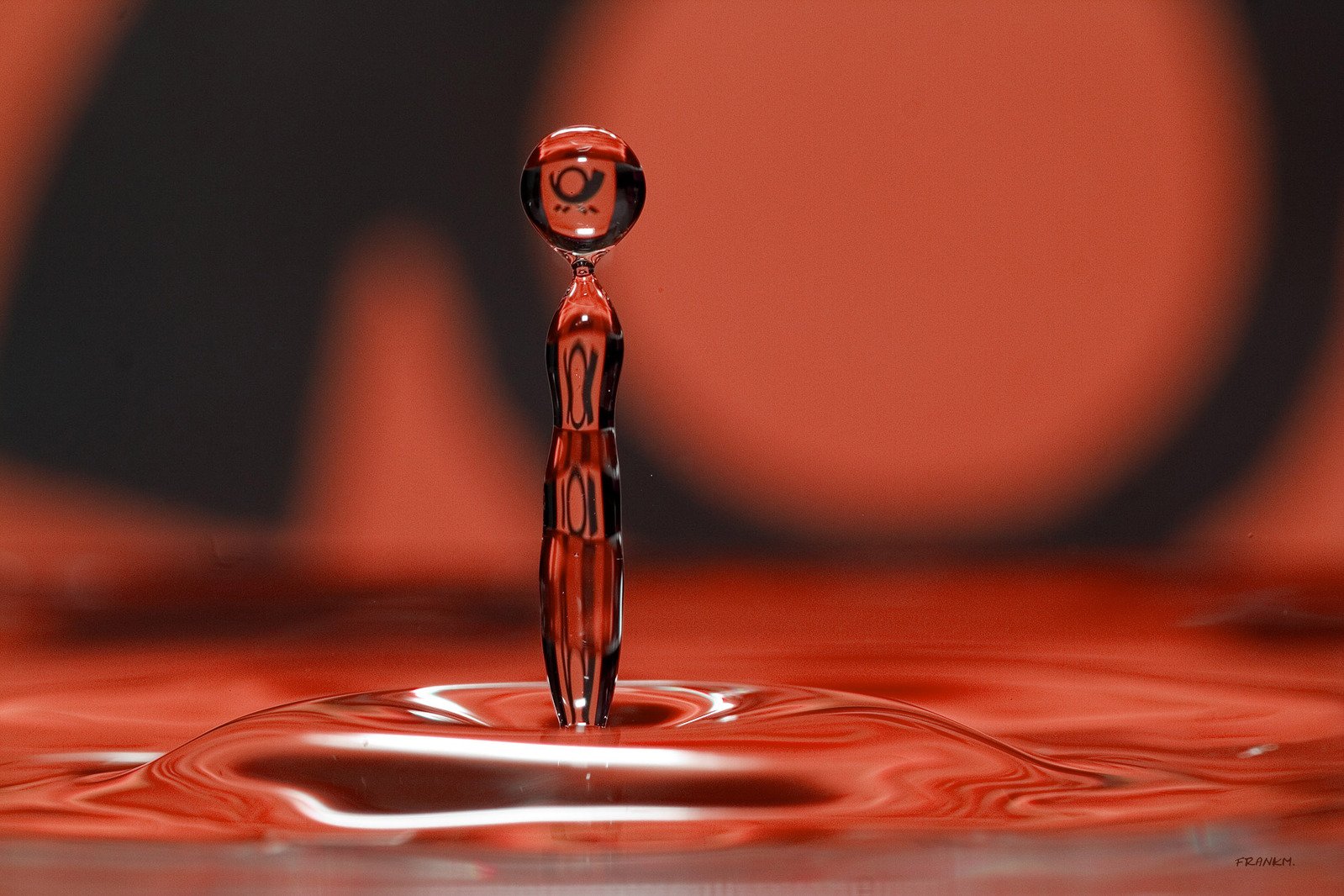 a red liquid drop shaped like an human figure