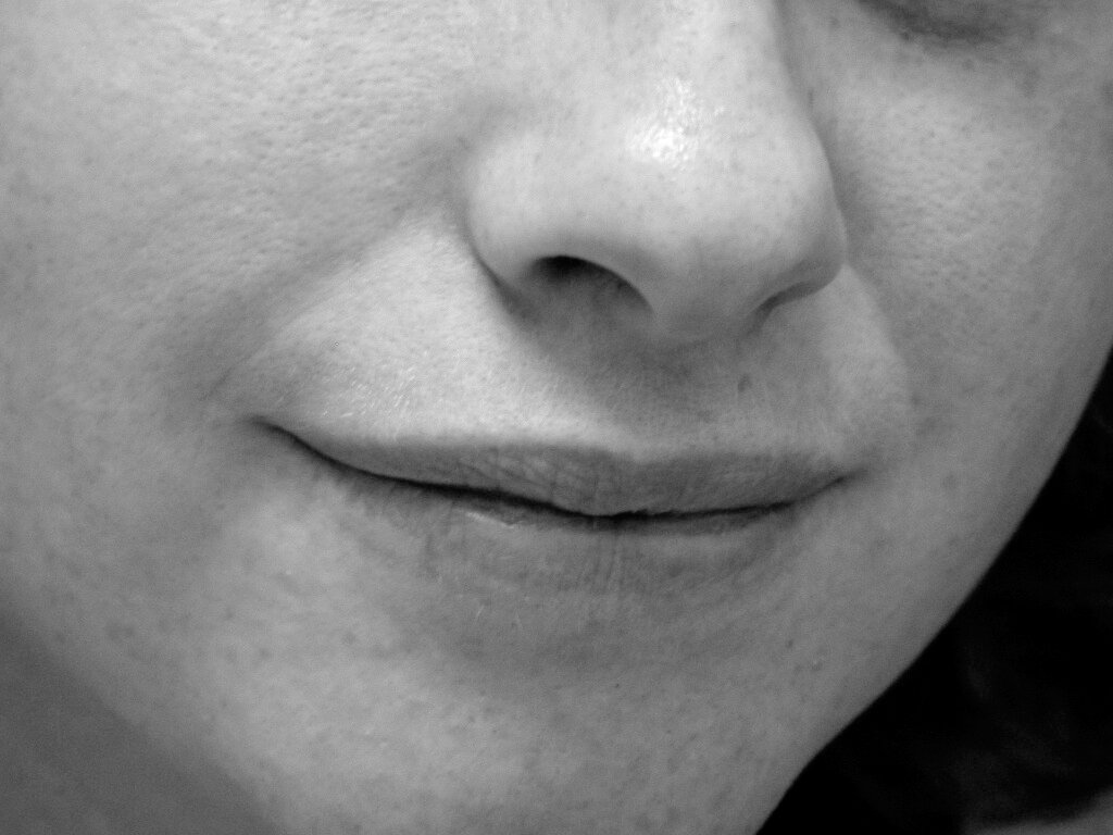 the nose and lips of a woman with brown hair