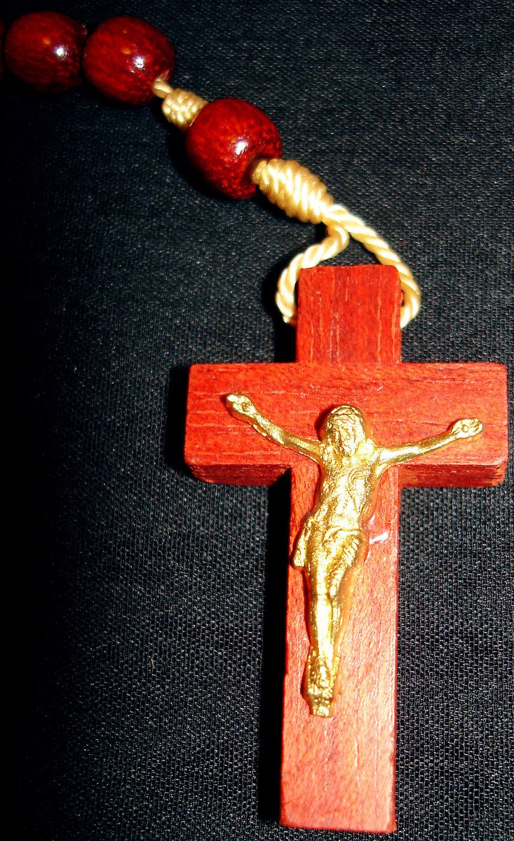 a red cross with gold jesus crucifix necklace