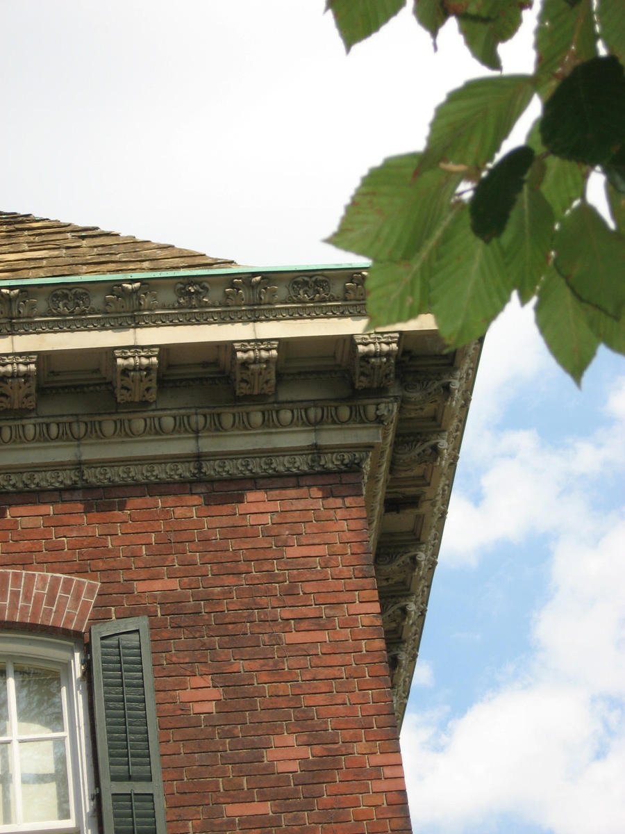 a brick building with a clock and window