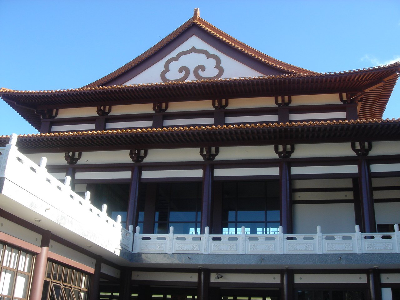 an asian building has brown and white tiles on it