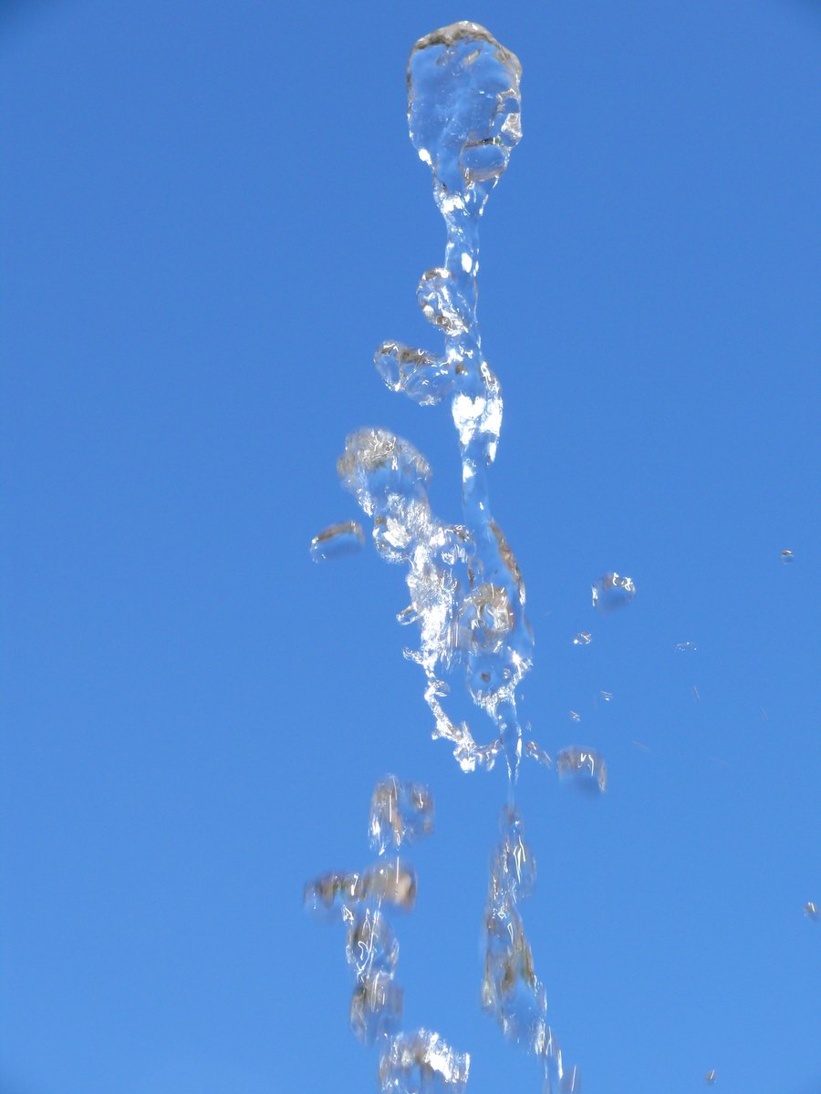 water pouring from faucet and blue sky