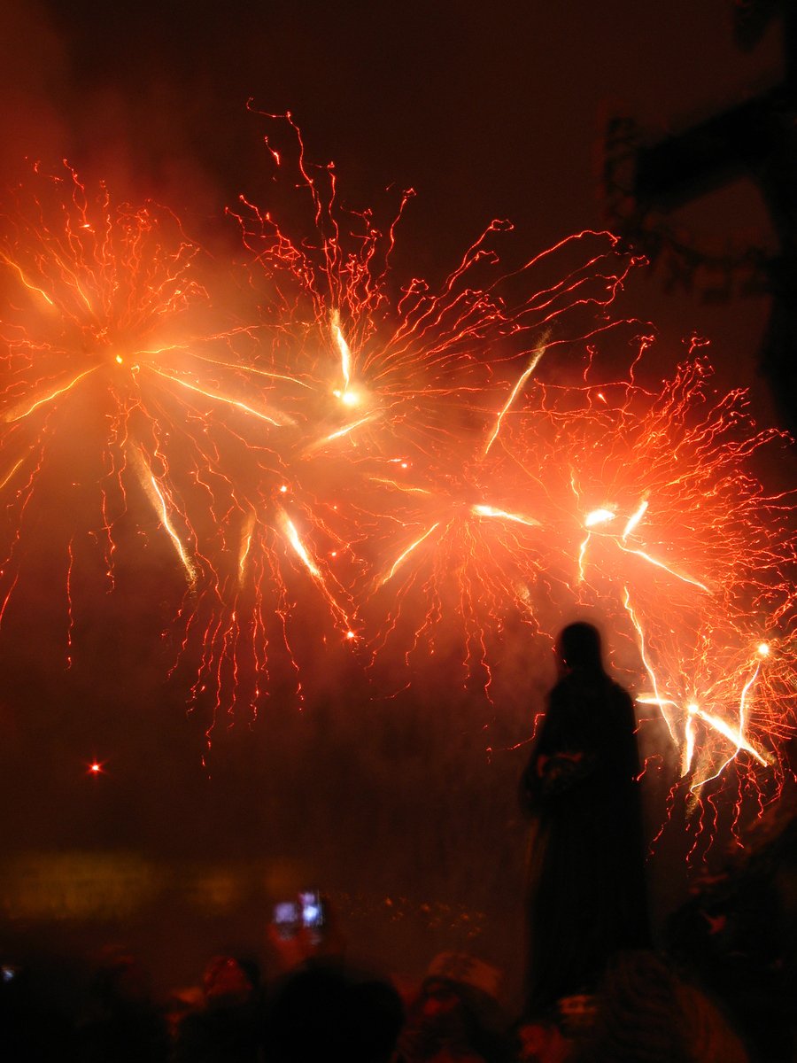 people looking up at fireworks in the sky