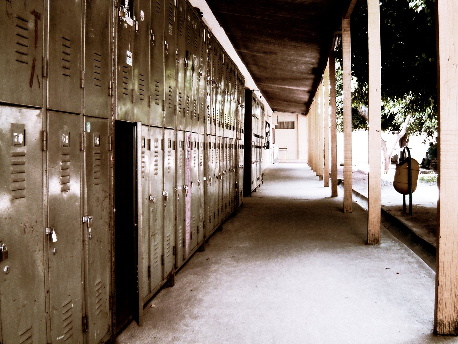 a row of lockers next to a walkway