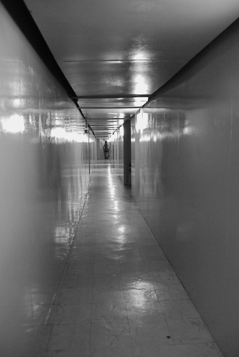 long hallway in an office building with many lights