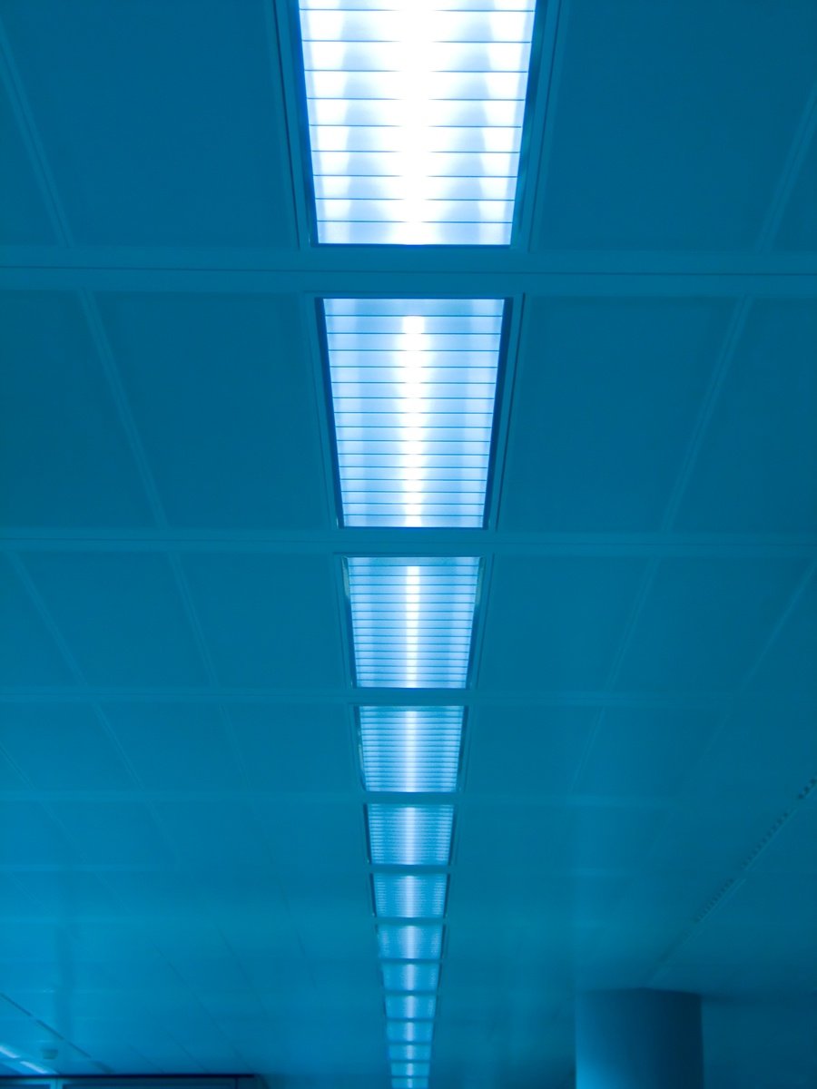 a long hallway has blue lights in it