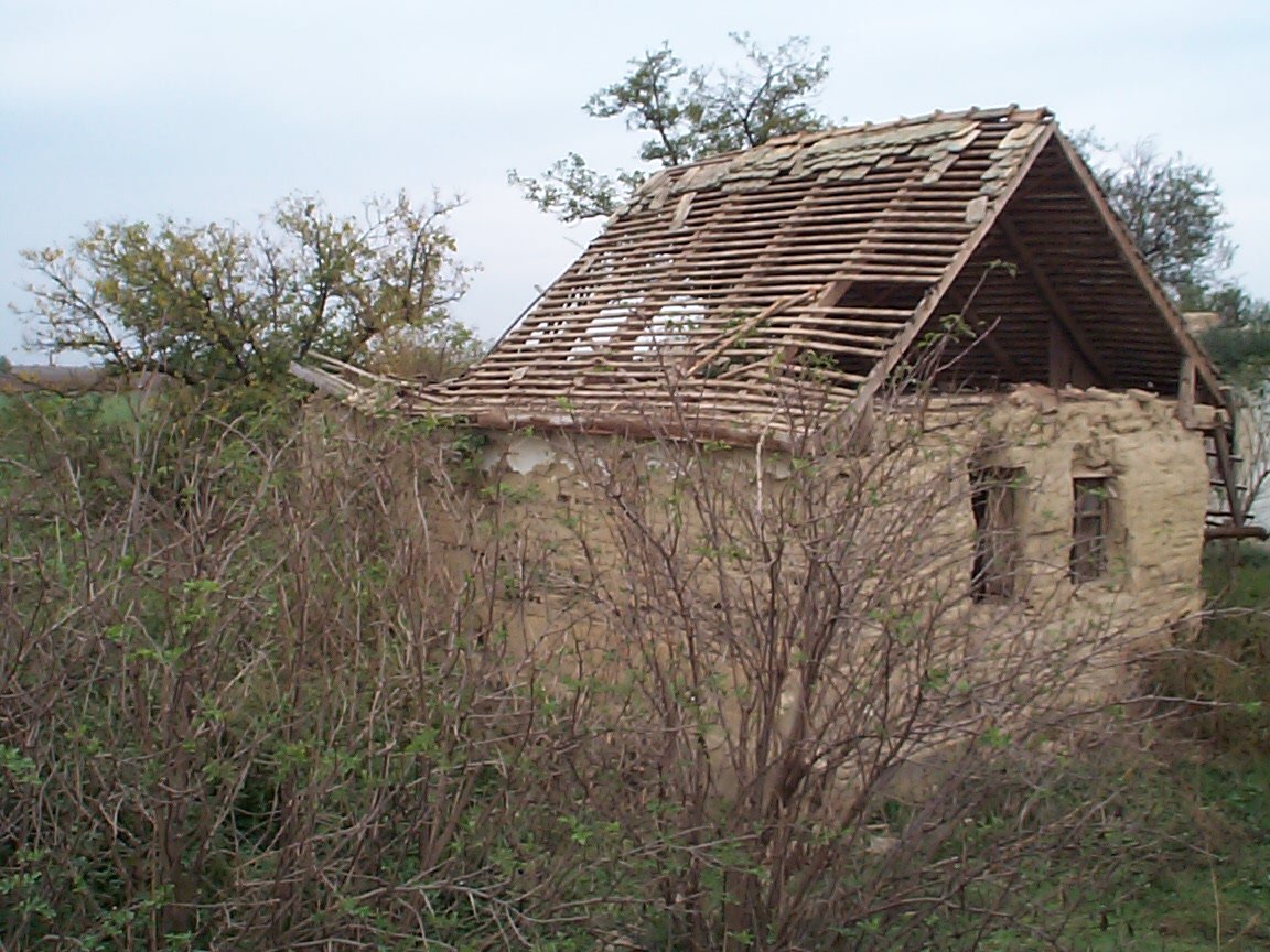 a house that has been destroyed and has a roof that looks like it's out of place