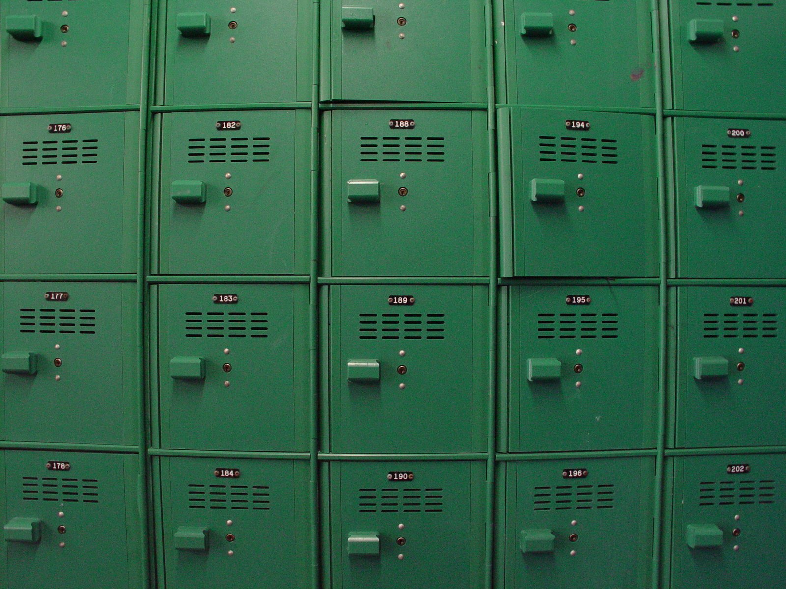 a wall filled with lots of green lockers